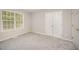 Bedroom features plush carpeting, double closet, and neutral color palette at 2735 Clifton Ave, Creedmoor, NC 27522
