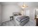 Bedroom features plush carpeting, ceiling fan, and soft, neutral color palette at 2735 Clifton Ave, Creedmoor, NC 27522