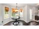 Bright breakfast nook with bay window, chandelier, and dark hardwood floors at 2735 Clifton Ave, Creedmoor, NC 27522