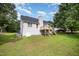 Expansive backyard view shows siding, deck with stairs, and generous lawn at 2735 Clifton Ave, Creedmoor, NC 27522