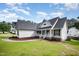Inviting home exterior with white siding, gray roof, lush lawn, and inviting front porch at 2735 Clifton Ave, Creedmoor, NC 27522