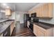 Modern kitchen features stainless steel appliances, light wood cabinetry, and dark countertops at 2735 Clifton Ave, Creedmoor, NC 27522