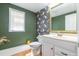 Bathroom featuring wallpaper, a mirror, and natural light at 3010 Blueberry Ln, Chapel Hill, NC 27516