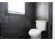Chic bathroom featuring black marble tile, bright natural light, and modern fixtures at 3010 Blueberry Ln, Chapel Hill, NC 27516