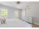 A bright bedroom featuring two windows and a modern dresser with sliding barn door at 3010 Blueberry Ln, Chapel Hill, NC 27516