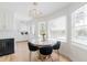 Stylish dining area with a round marble table, modern chandelier, and bright natural light at 3010 Blueberry Ln, Chapel Hill, NC 27516