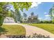 Charming two-story home with a welcoming front porch and a long driveway leading to a detached garage at 3010 Blueberry Ln, Chapel Hill, NC 27516