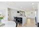 Open-concept kitchen island with seating, black cabinets, and view into the living space at 3010 Blueberry Ln, Chapel Hill, NC 27516