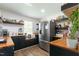Updated kitchen with butcher block countertops, stainless refrigerator and open shelving at 3010 Blueberry Ln, Chapel Hill, NC 27516