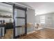 An open-concept living room featuring new floors and sliding barn door to kitchen at 3010 Blueberry Ln, Chapel Hill, NC 27516