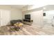 This living room includes a gray sofa and mounted TV at 3010 Blueberry Ln, Chapel Hill, NC 27516