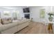 Bright living room with neutral decor, modern fireplace, wood floors, and large windows for natural light at 3010 Blueberry Ln, Chapel Hill, NC 27516