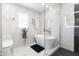 Bright bathroom with a soaking tub and marble-style tile at 3010 Blueberry Ln, Chapel Hill, NC 27516