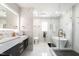 Spa-like main bathroom with dual vanity, soaking tub, and frameless glass shower at 3010 Blueberry Ln, Chapel Hill, NC 27516