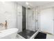Sleek, modern bathroom with glass shower featuring black hexagonal tile and gold fixtures at 3010 Blueberry Ln, Chapel Hill, NC 27516