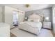 Stunning main bedroom showcases a tufted headboard, gray accent wall, and neutral carpeting at 3010 Blueberry Ln, Chapel Hill, NC 27516