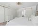 Bright main bedroom features white walls, barn door, and a stylish contemporary light fixture at 3010 Blueberry Ln, Chapel Hill, NC 27516