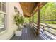 Inviting covered porch with wood ceiling, decorative plants, and stylish furniture for relaxing outdoors at 3010 Blueberry Ln, Chapel Hill, NC 27516