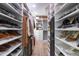Spacious walk-in closet features custom shelving, hanging rods, and a luxe chandelier at 3010 Blueberry Ln, Chapel Hill, NC 27516