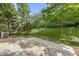 Enjoy the tranquil backyard with its patio and lush green space, framed by mature trees at 3033 Remington Oaks Cir, Cary, NC 27519