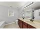 Bathroom with a double sink vanity, large mirror, and window for natural light at 3033 Remington Oaks Cir, Cary, NC 27519