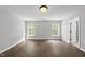 A spacious bedroom features wood-look flooring and two windows that provide ample natural light at 3033 Remington Oaks Cir, Cary, NC 27519