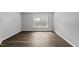 An airy bedroom features wood-look flooring with windows for natural light at 3033 Remington Oaks Cir, Cary, NC 27519