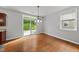 Bright dining area featuring hardwood floors, modern lighting, and sliding glass doors to the backyard at 3033 Remington Oaks Cir, Cary, NC 27519