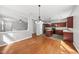 Open floor plan with hardwood floors connecting the dining area, living room, and kitchen at 3033 Remington Oaks Cir, Cary, NC 27519