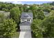 Inviting exterior view of the home showcasing mature trees, a two-car garage, and a meticulously maintained lawn at 3033 Remington Oaks Cir, Cary, NC 27519