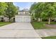Traditional two-story home features a two-car garage, landscaped front yard, and inviting curb appeal at 3033 Remington Oaks Cir, Cary, NC 27519