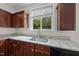 Kitchen featuring granite countertops, cherry wood cabinets, and a window with a serene view at 3033 Remington Oaks Cir, Cary, NC 27519