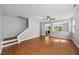 Spacious living room with hardwood floors, large windows, and a staircase leading to the upper level at 3033 Remington Oaks Cir, Cary, NC 27519