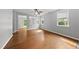 Open-concept living room with hardwood floors, abundant natural light, and neutral paint at 3033 Remington Oaks Cir, Cary, NC 27519