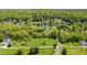 Aerial view showcases sprawling acreage with mature trees, offering a sense of privacy and tranquility at 309 Appaloosa Trl, Bahama, NC 27503