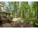 Spacious backyard with deck, playset, and mature trees offers a serene outdoor retreat at 309 Appaloosa Trl, Bahama, NC 27503