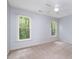 Neutral toned bedroom featuring carpet flooring, dual windows and a ceiling fan at 309 Appaloosa Trl, Bahama, NC 27503