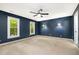 A spacious, carpeted bedroom is illuminated by two stylish sconces, enhancing its cozy ambiance at 309 Appaloosa Trl, Bahama, NC 27503