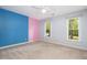 Bright bedroom featuring a ceiling fan, carpet flooring, and dual windows for natural light at 309 Appaloosa Trl, Bahama, NC 27503