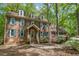 Charming brick home featuring dormer windows, green shutters, and a well-maintained front yard with mature trees at 309 Appaloosa Trl, Bahama, NC 27503