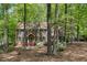 Traditional brick home with green shutters and dormer windows, nestled among mature trees and colorful azalea bushes at 309 Appaloosa Trl, Bahama, NC 27503