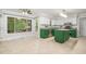 Modern kitchen with green cabinets, white walls, stainless steel appliances and views to the screen porch at 309 Appaloosa Trl, Bahama, NC 27503