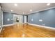 Spacious living room with hardwood floors, leading to adjacent rooms, providing an open and airy feel at 309 Appaloosa Trl, Bahama, NC 27503