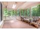Charming screened-in porch with comfortable chairs and a ceiling fan provides a peaceful spot to enjoy nature at 309 Appaloosa Trl, Bahama, NC 27503
