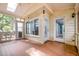 Relaxing sunroom offers a comfortable space with wood floors and multiple access doors to the main home and the exterior at 309 Appaloosa Trl, Bahama, NC 27503
