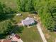 Breathtaking aerial view of a secluded home with a long private driveway and additional outbuilding surrounded by beautiful trees at 318 Duck Pond Ln, Clayton, NC 27520
