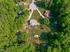 Wide aerial view showcasing a home with a long private driveway and outbuilding surrounded by lush foliage and trees at 318 Duck Pond Ln, Clayton, NC 27520
