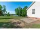 Spacious backyard features a shed, lush green grass, mature trees, and a brick patio at 318 Duck Pond Ln, Clayton, NC 27520