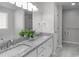 Bathroom featuring a double vanity with granite counters and modern faucets at 318 Duck Pond Ln, Clayton, NC 27520