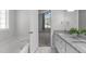 Bright bathroom featuring a tub, granite vanity, and tile flooring, connected to the bedroom at 318 Duck Pond Ln, Clayton, NC 27520